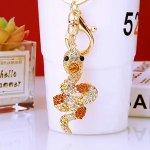 Detailed view of the gold-plated snake keychain with sparkling rhinestones and crystal