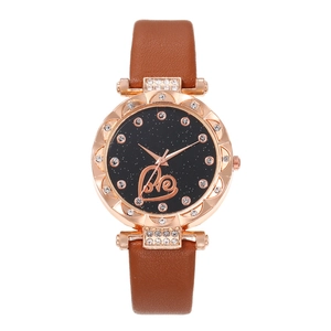 Close-up of starry black dial with Love heart design and rose gold rhinestone bezel