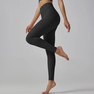 Close-up of wide high-waisted band on black thermal leggings showing seamless stitching