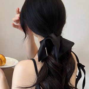 Large black satin scrunchie bow for ponytail styling shown on model back view