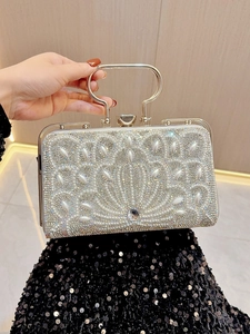 Detail of silver evening bag featuring pearl and rhinestone fan pattern with metal handle