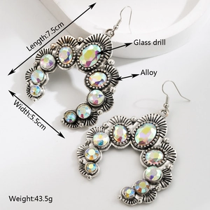 Detail view of large bohemian geometric earrings with colorful glass stones and silver alloy