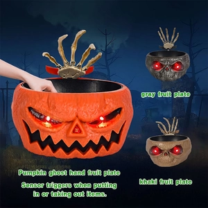 Animated Halloween candy bowl with skeletal hand and glowing red eyes for spooky decor