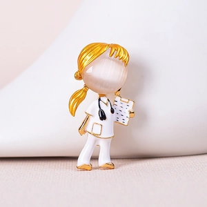 Macro shot of a medical nurse brooch with opal head and gold-plated stethoscope detail