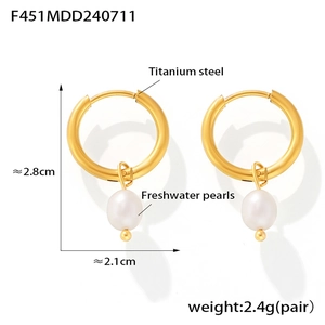 Detail view of 18k gold plated titanium steel earrings with white freshwater pearls