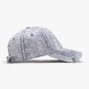 Vintage washed denim baseball cap with distressed torn edges and side metal buckle