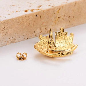 Exaggerated irregular spiral gold stud earrings with a textured rock-like finish