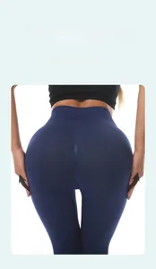 Detailed close-up of dark blue high-waisted yoga pants with peach butt lift contouring