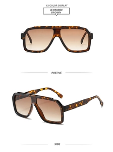 Detail view of square leopard print sunglasses with thick frames and brown gradient lenses
