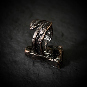 Macro shot of vintage feather ring with antique bronze plating and intricate textures