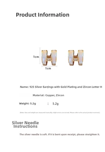 Macro view of gold-plated H-shaped earrings with cubic zirconia and 925 silver pins
