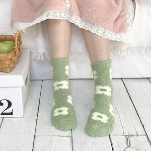 Thick coral fleece thermal socks with green base and white floral pattern for winter warmth