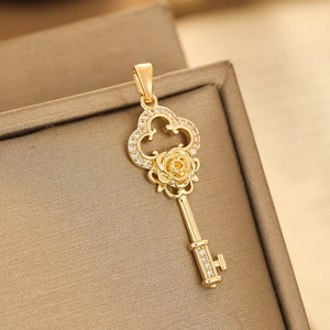 Golden micro-pave zircon key pendant with rose design on a textured display box