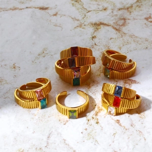 Close-up of golden stainless steel rings with colorful rectangular birthstones