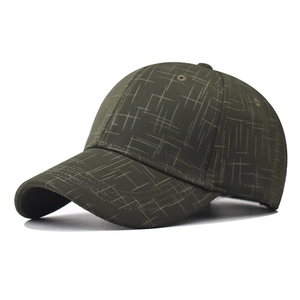 Detail of olive green baseball cap showing checkered fabric texture and peak stitching