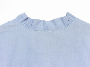 Detail of blue and white striped poplin shirt showing layered ruffle stand collar design
