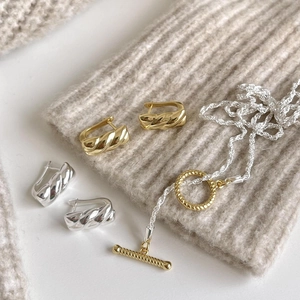 925 silver twist hoop earrings and mixed metal necklace with OT clasp on knit fabric