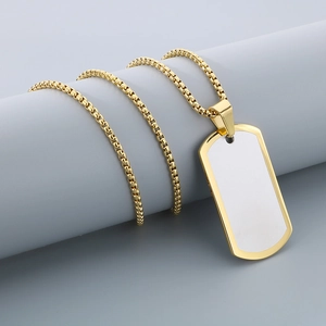 Close-up of blank gold rectangle dog tag pendant with stainless steel box chain