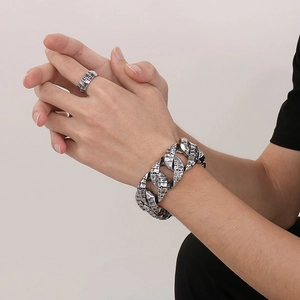 Close-up of vintage silver dragon scale Cuban chain bracelet and matching men's ring