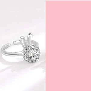 Detailed close-up of a silver open ring with rabbit ear design and clustered zircons