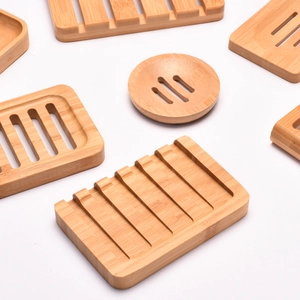 Minimalist bamboo soap dishes in various shapes featuring natural drainage slots and wood grain