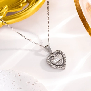Détail du pendentif cœur en argent avec zircons baguette et pavés sur une chaîne à maillons fins