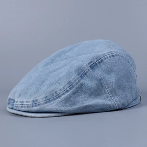 Close-up of light blue washed denim fabric texture on a vintage flat cap