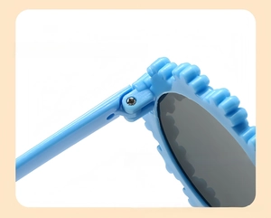 Close-up of bright blue flower-shaped frame and durable metal hinge for kids sunglasses