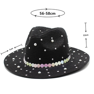 Detailed view of black straw sun hat with pearls and sequins showing 7cm wide brim size