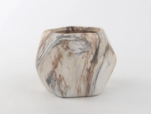 Detailed macro view of ceramic succulent pot with marble pattern and geometric shape