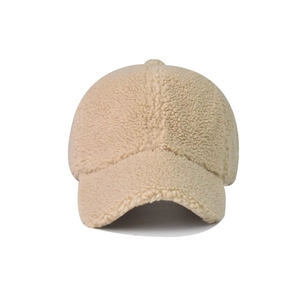 Dettaglio della trama in lana d'agnello beige su un cappello baseball invernale