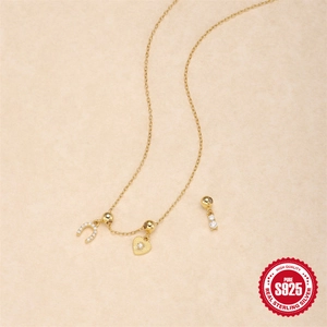Golden S925 sterling silver horseshoe and heart zircon necklace on beige leather