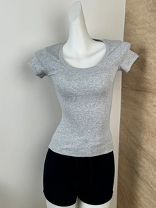 Close-up of gray ribbed knit T-shirt fabric texture on a white female mannequin