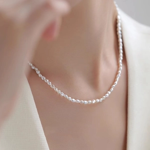Elegant natural baroque freshwater pearl necklace worn by a model as a choker length