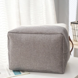 Foldable grey cotton linen storage basket with brown leather handles for home organizing