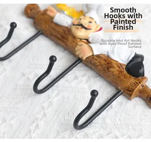 Detail of creative chef wall hook with smooth round hooks and paint finish