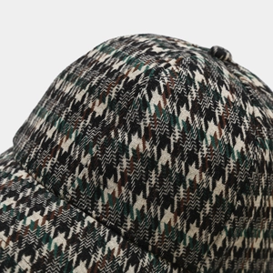 Close-up of vintage houndstooth pattern fabric on a stylish baseball cap with sharp texture