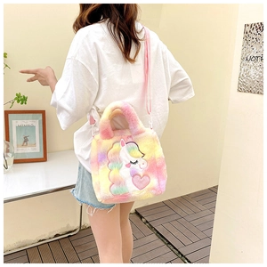 Rainbow plush unicorn handbag shown on a model for size and style reference