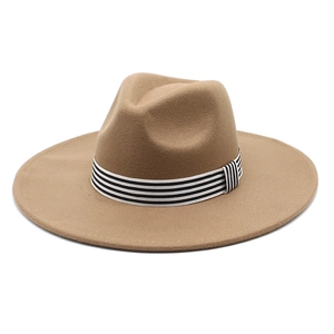 Detail of camel wool felt fedora featuring a stylish black and white striped hat band