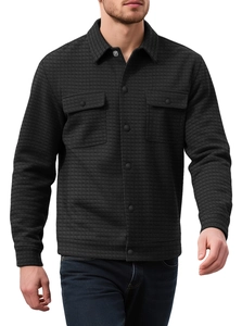 Close-up of black men's quilted shirt jacket with textured square pattern and chest pockets