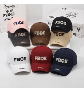 Detail view of cotton baseball caps with FBQE embroidery in eight different colors