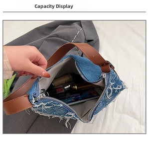 Internal view of the denim shoulder bag with leather strap showing spacious storage space