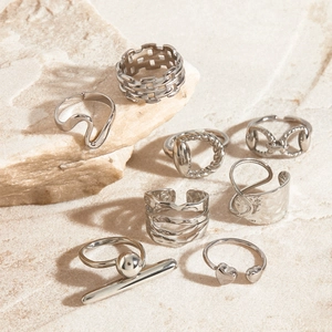 Set of 8 silver stainless steel rings featuring geometric, chain and heart designs