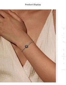Close-up of S925 silver tennis bracelet featuring a black heart charm with sparkling zircon