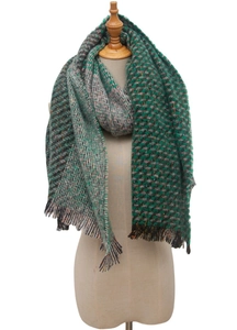 Detail of multi-color knit scarf with herringbone pattern and fringe on a mannequin