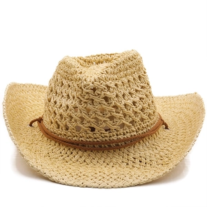 Detail of hollow woven straw cowboy hat in beige with decorative brown cord trim
