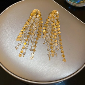 Macro view of 18k gold plated long fringe earrings with crystal beads and sequins