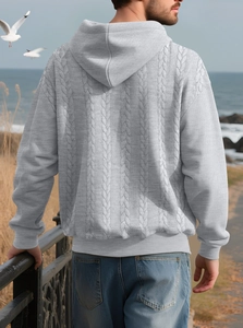 Outdoor shot showing back detail of light grey men's hoodie with cable knit pattern