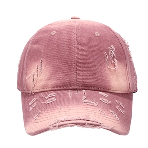 Retro washed pink distressed baseball cap with ripped details and vintage streetwear style