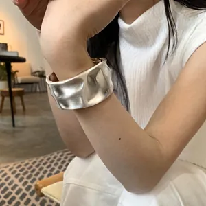 Minimalist wide silver hammered metal cuff bangle with an artistic matte finish for women